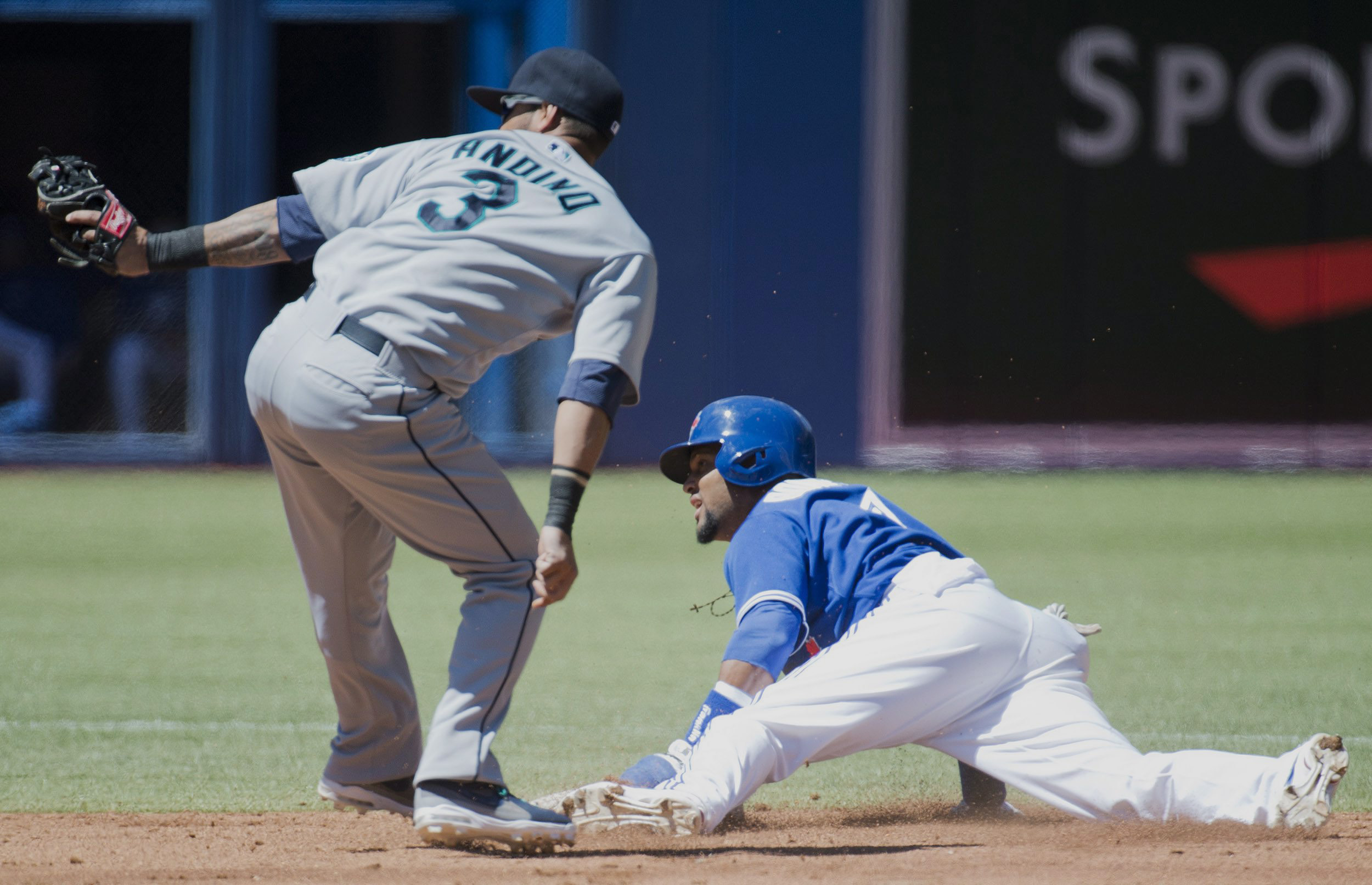 Toronto's Emilio Bonifacio, right, steals second base as Seattle shortstop Robert Andino, left, is late on the tag during second inning Sunday.