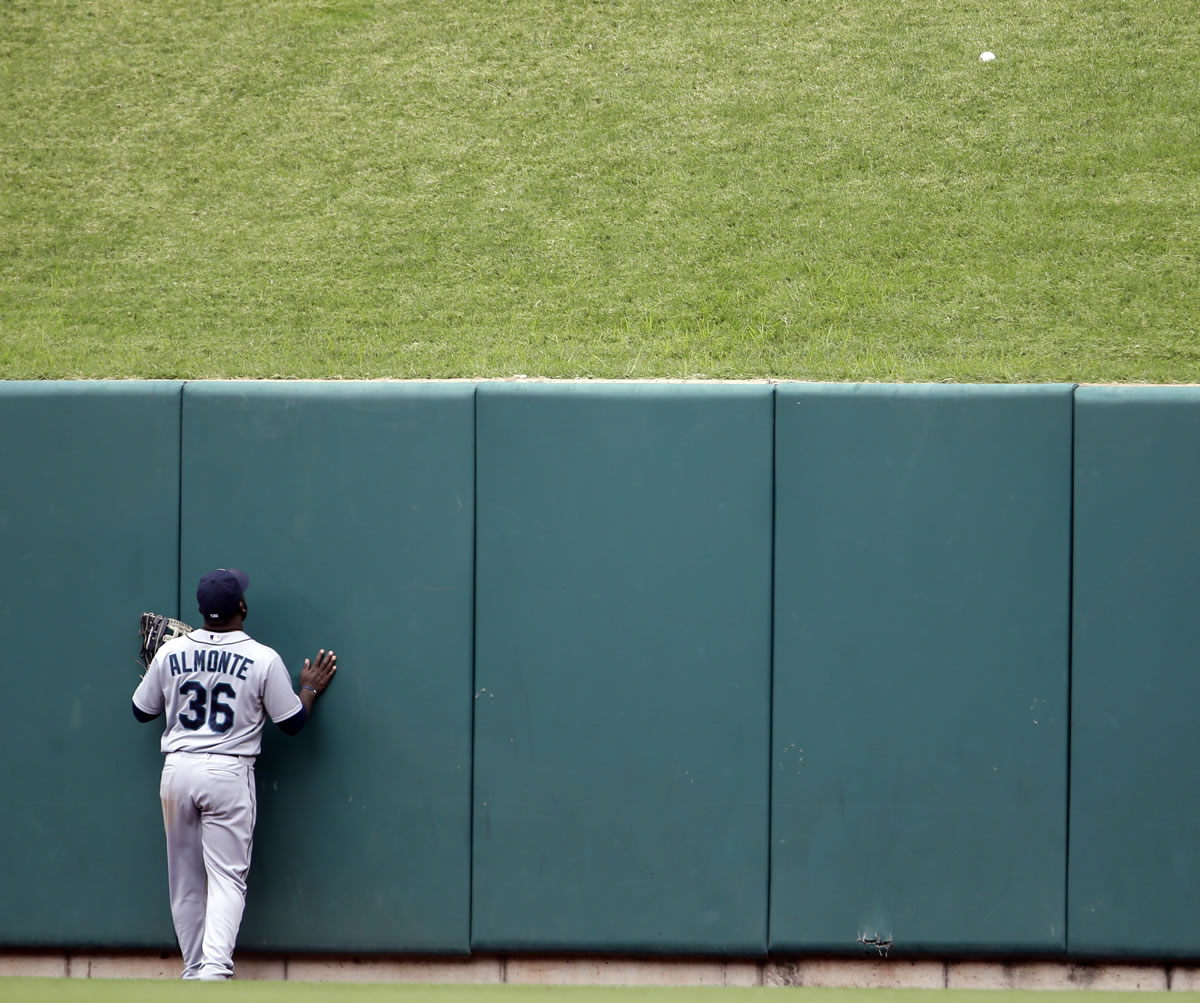 Seattle Mariners center fielder Abraham Almonte watches as a two-run home run by St.