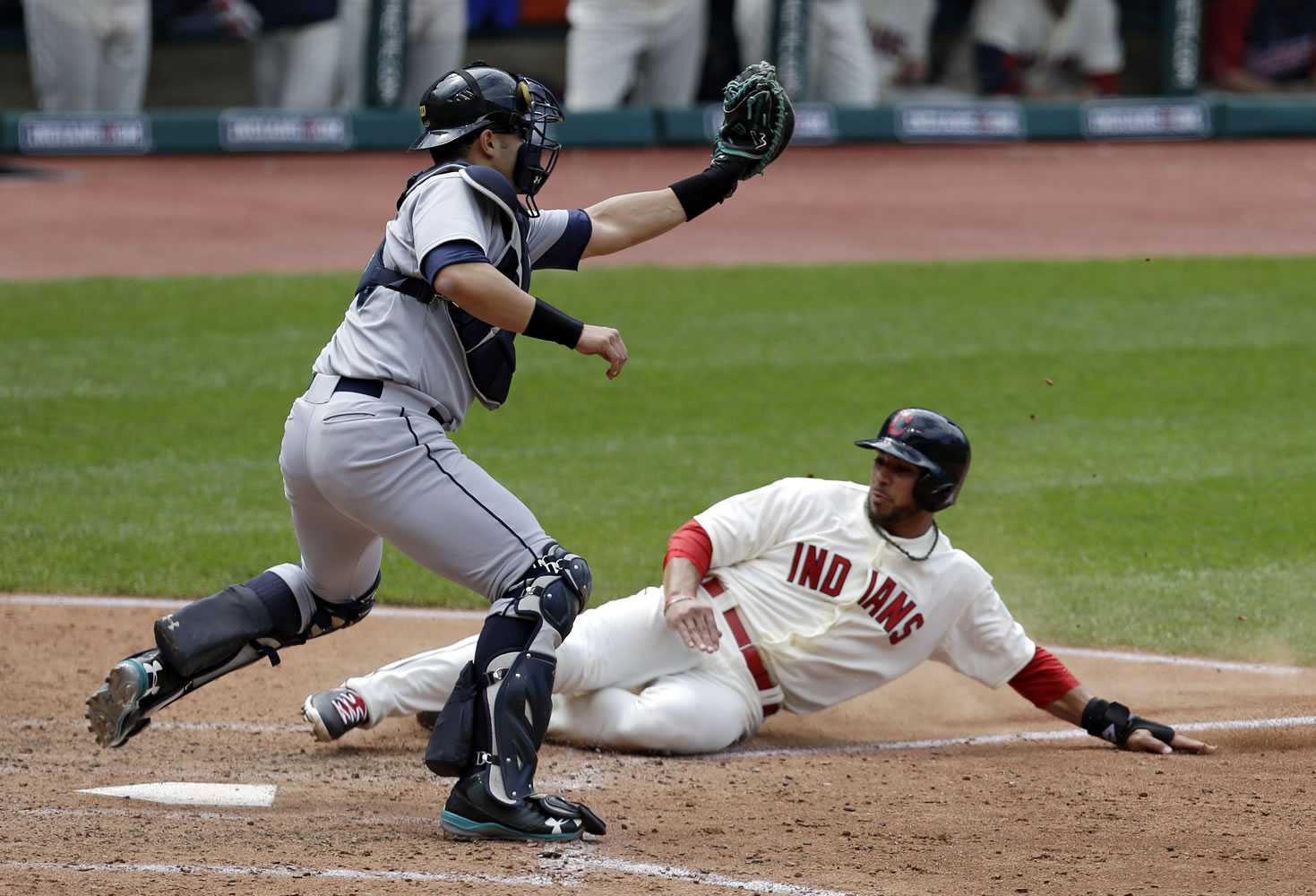 Cleveland Indians' Mike Aviles, right, scores as Seattle Mariners catcher Jesus Montero waits for the ball in the sixth inning Saturday at Cleveland.
