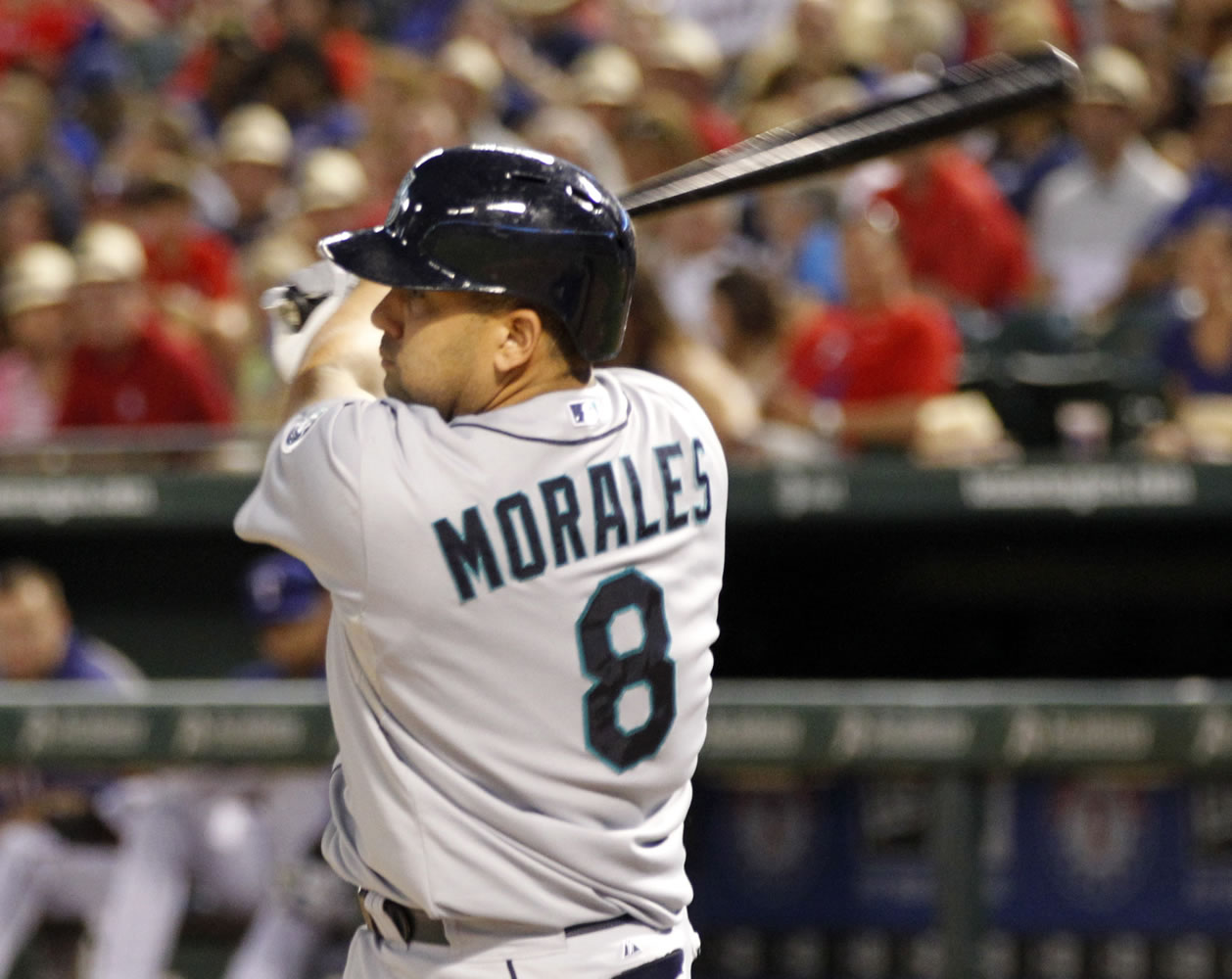 Seattle Mariners designated hitter Kendrys Morales follows through on a two-run single during the sixth inning of a baseball game Tuesday, July 2, 2013, in Arlington, Texas. +(AP Photo/John F.