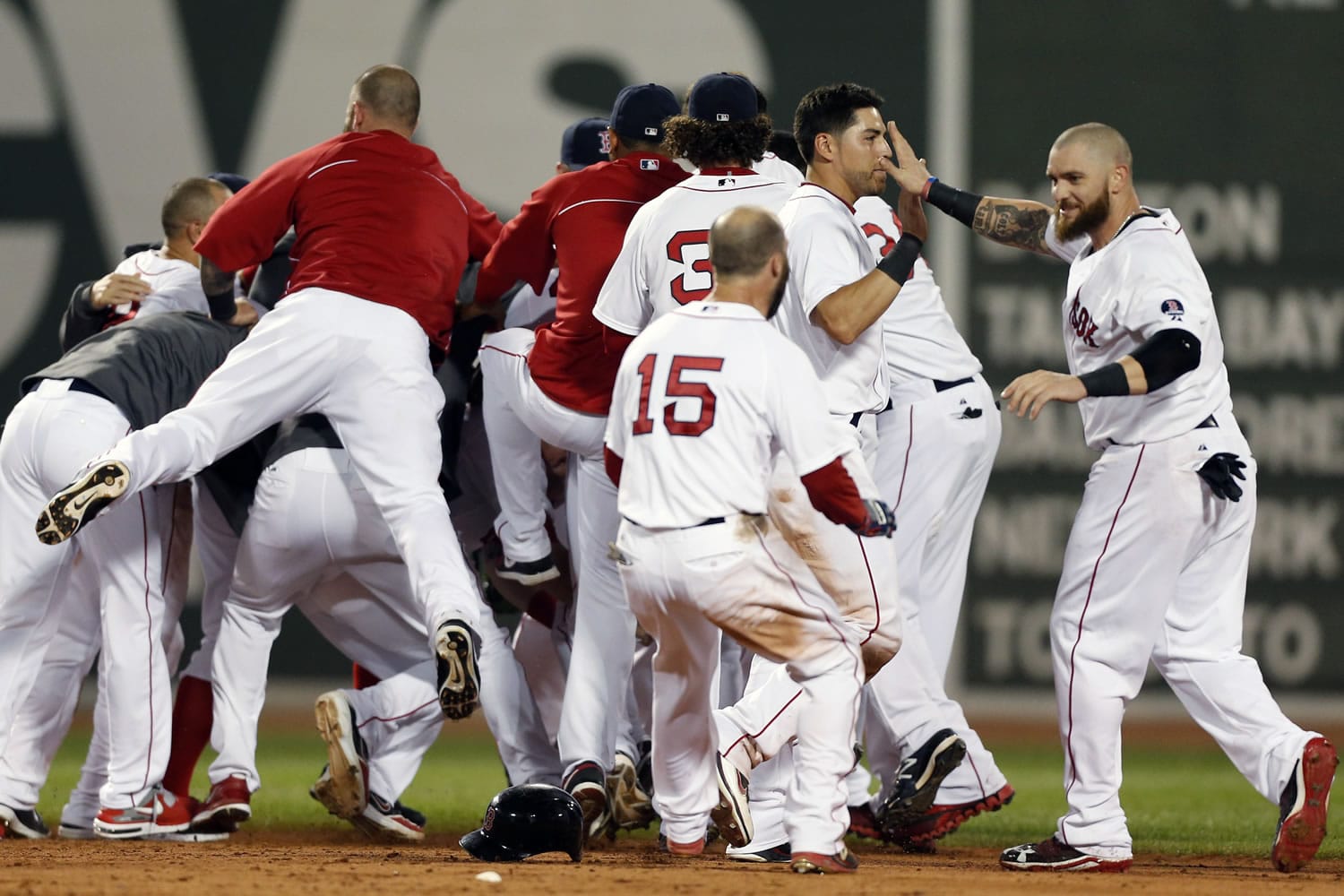 The Boston Red Sox including Jonny Gomes, right, Jacoby Ellsbury, second from right, and Dustin Pedroia celebrate after a walkoff-single by Daniel Nava that scored Pedroia in the ninth inning Thursday.