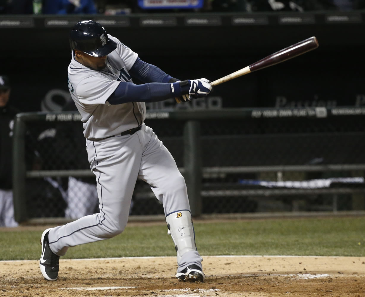 Seattle Mariners' Franklin Gutierrez hits a two-run double off Chicago White Sox starting pitcher Jose Quintana, scoring Dustin Ackley and Brendan Ryan, during the fifth inning Friday.