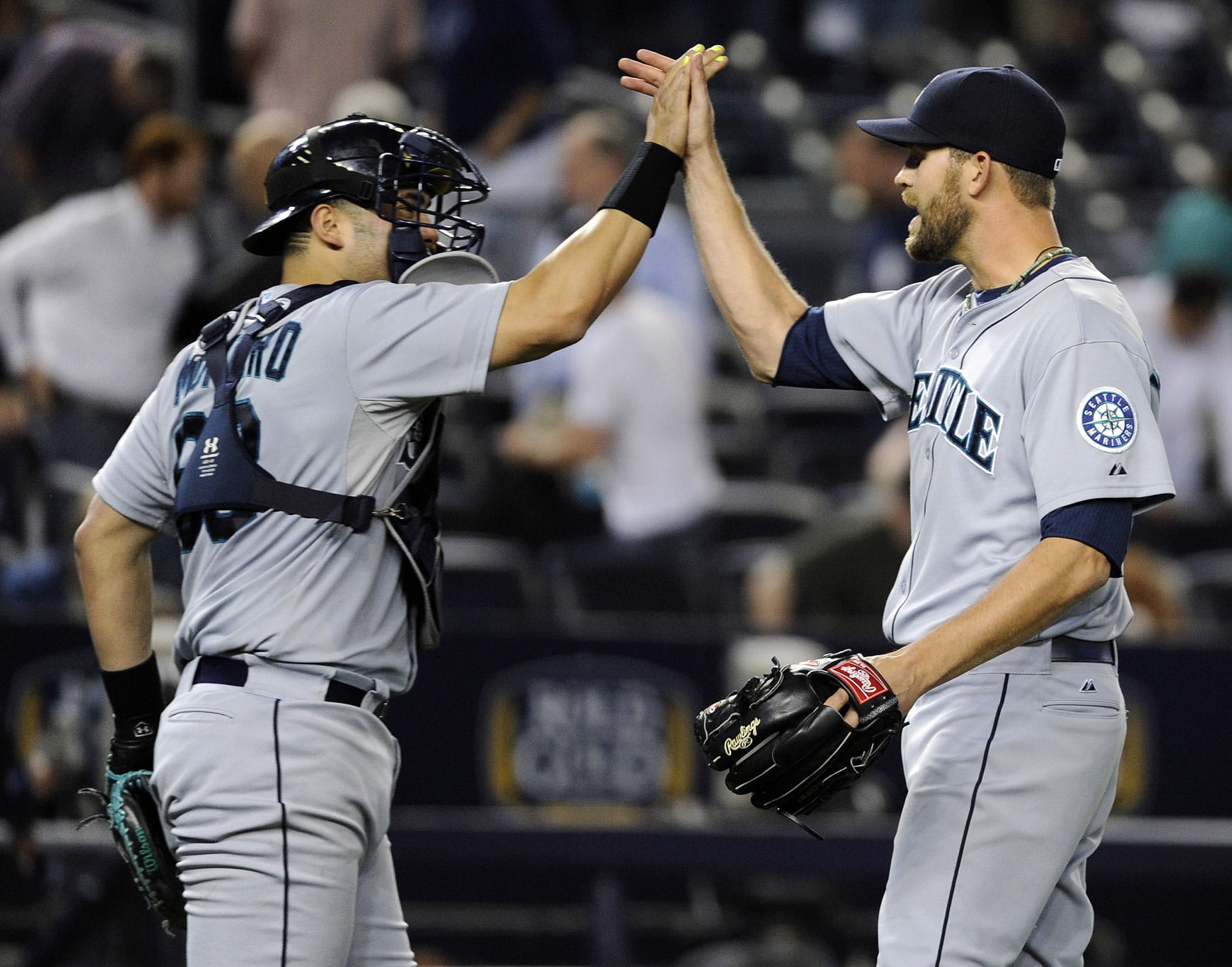 Seattle Mariners closer Tom Wilhelmsen celebrates with catcher Jesus Montero after defeating the New York Yankees, 3-2 on Thursday.