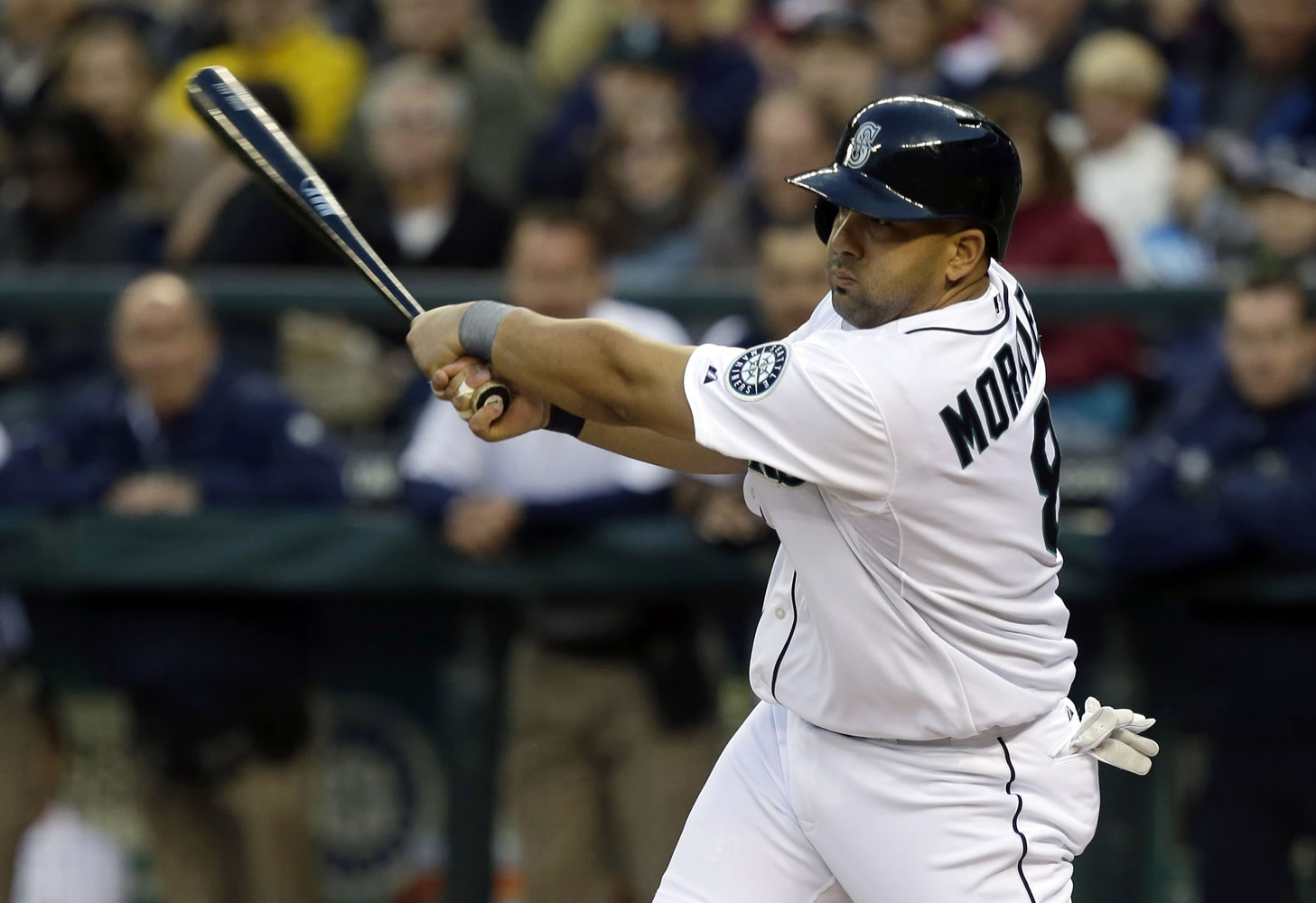 Seattle Mariners' Kendrys Morales hits a run-scoring single against the Houston Astros in the first inning Monday.