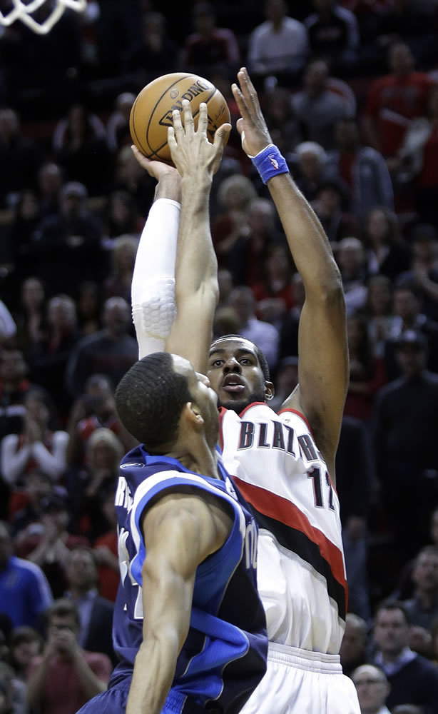 LaMarcus Aldridge, right, shoots over Dallas' Brandan Wright just before the buzzer to lift the Blazers to a win Tuesday.