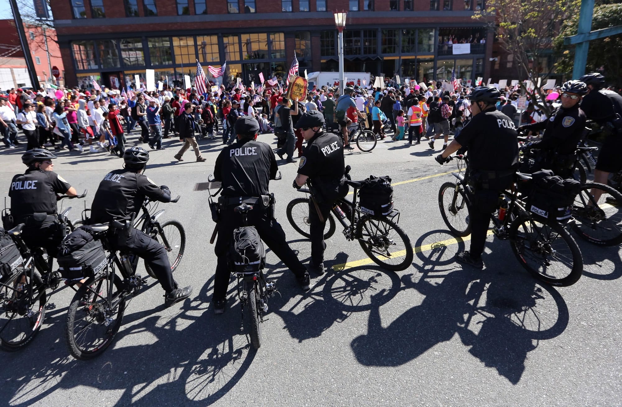 Police keep watch over demonstrators during a May Day rally in downtown Seattle on Wednesday.