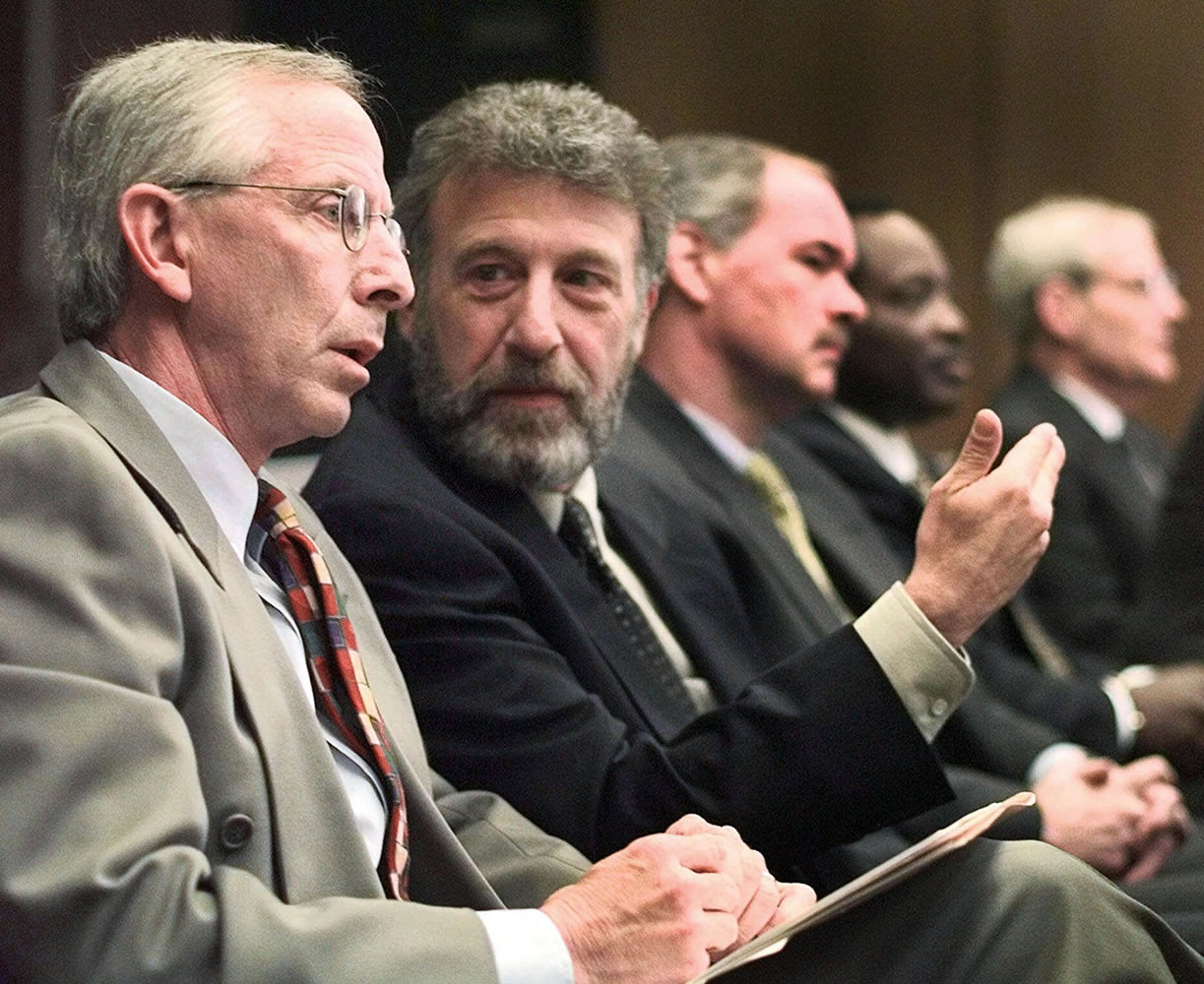 George Zimmer, center, founder of Men's Wearhouse, was fired by the company Wednesday.