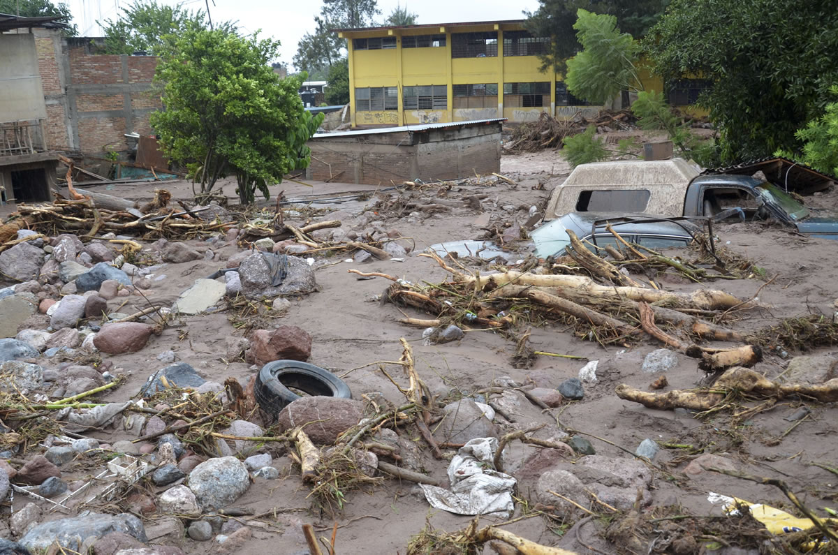 Mud and rubble cover vehicles and homes were swept away after a landslide caused by heavy rains came down on a low income neighborhood in the city of Chilpancingo, Mexico, on Monday.