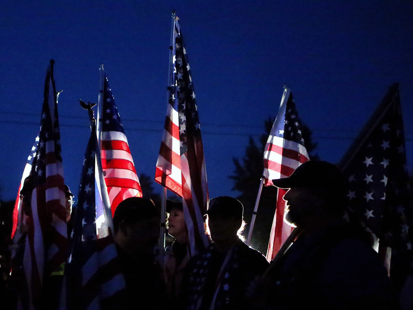 Members of the Patriot Guard file into a candlelight vigil outside Sparks Middle School in Sparks, Nev., on Wednesday.