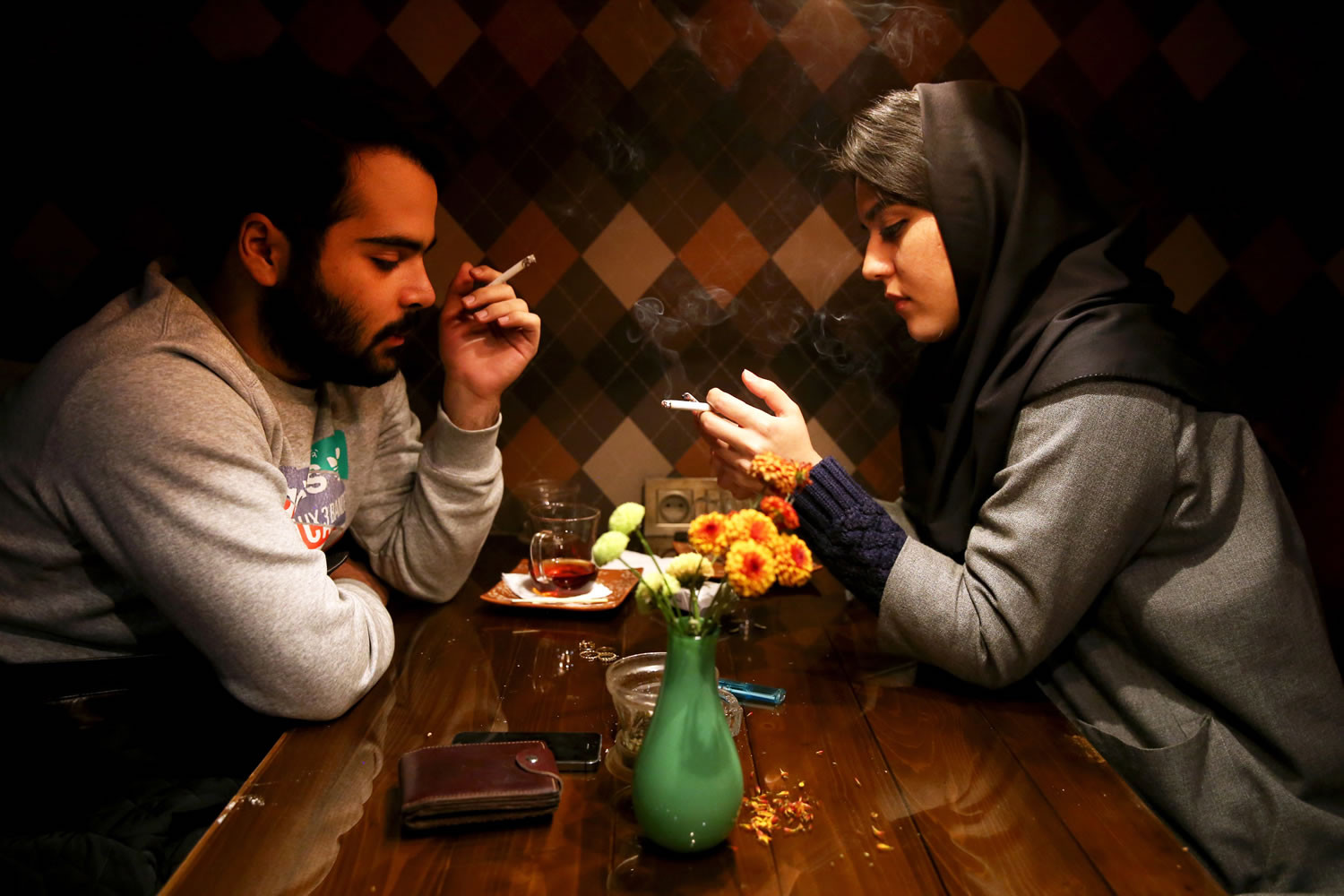 An Iranian man and a woman enjoy their time at a cafe in downtown Tehran, Iran, on Tuesday.