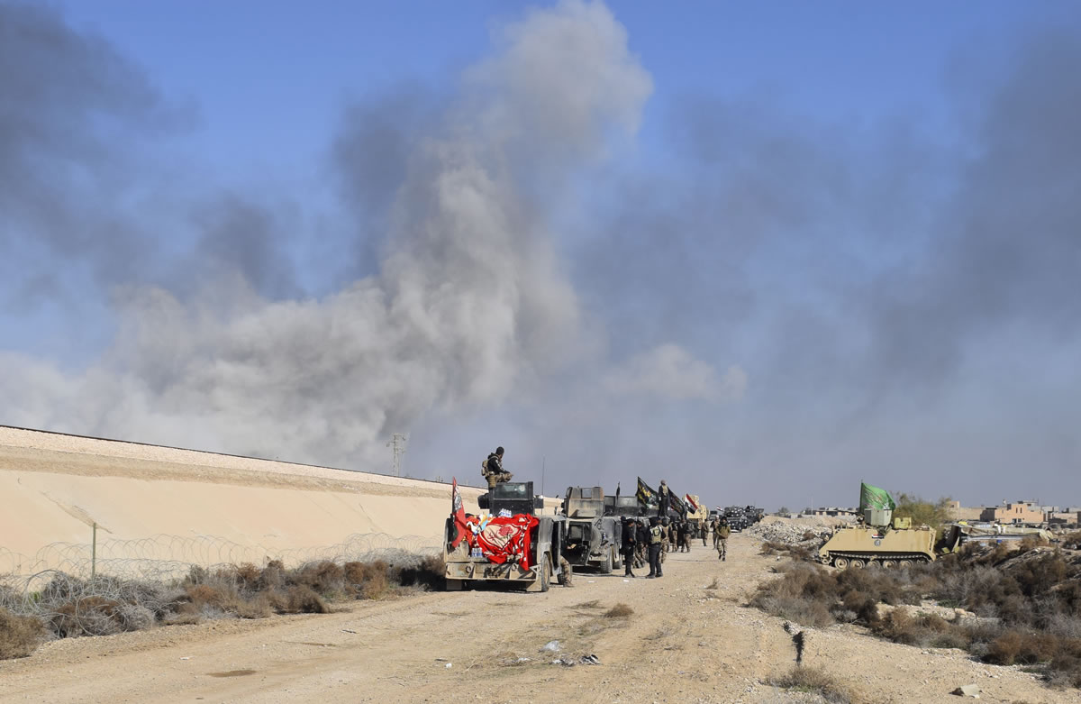 Smoke rises from Islamic State positions following a U.S.-led coalition airstrike as Iraqi Security forces advance Tuesday in Ramadi, 70 miles west of Baghdad, Iraq.
