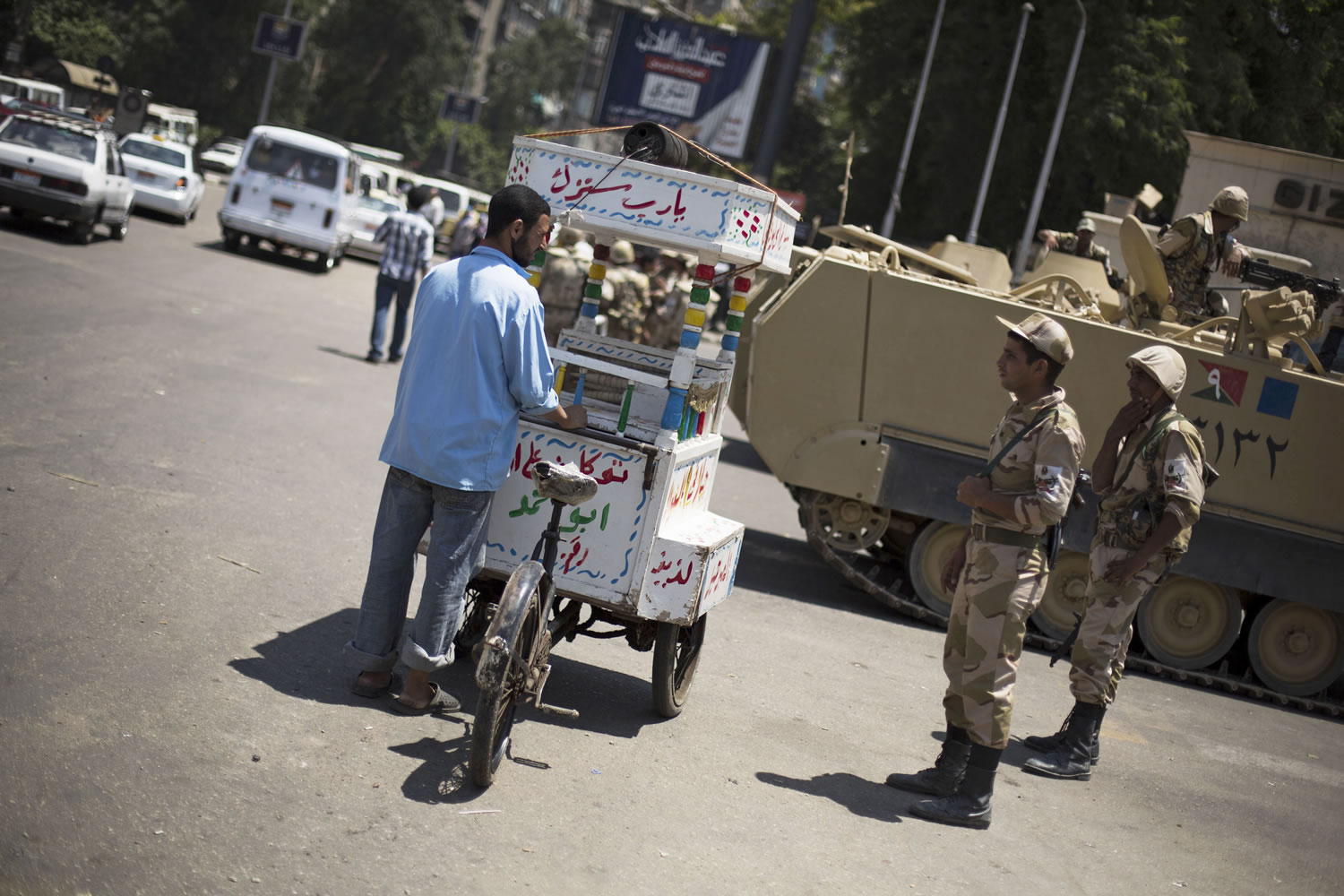 Egyptian soldiers talk to a street vendor while securing the area around Cairo University, where Muslim Brotherhood supporters have gathered to support ousted president Mohammed Morsi in Cairo, on Thursday.
