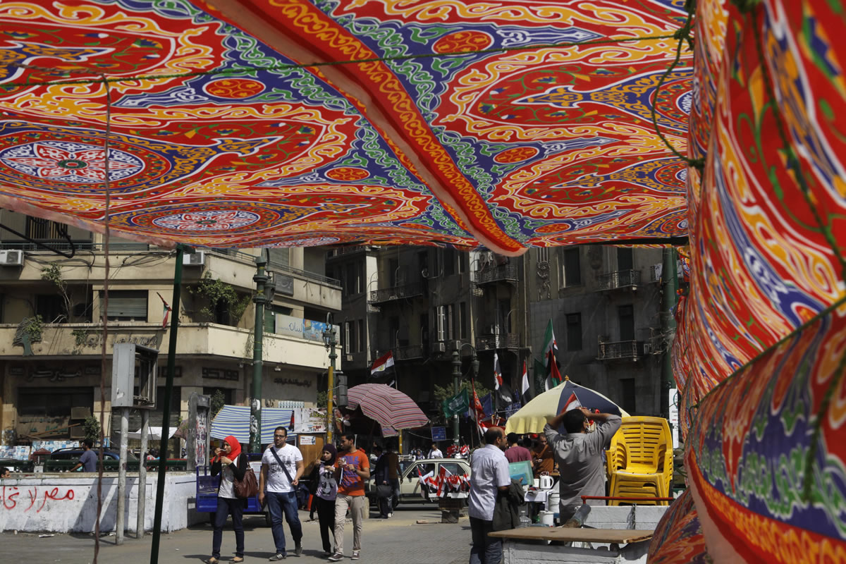 Egyptians looks through a decorated tent set by volunteers to offer a shade spot in Tahrir Square, the focal point of Egyptian uprising in Cairo, Egypt, on Tuesday.