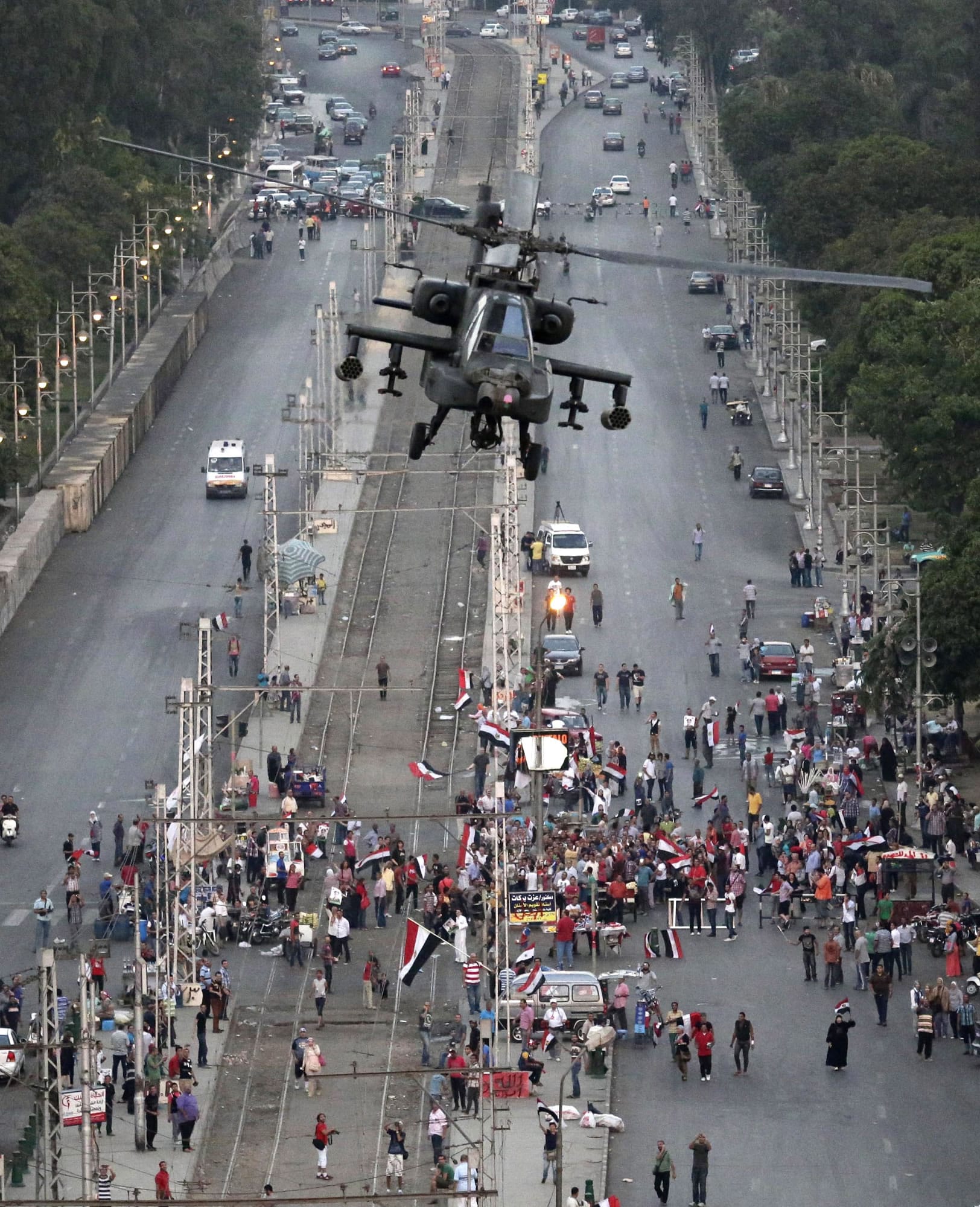A military attack helicopter flies over a street near the presidential palace, in Cairo, Egypt, Friday, July 5, 2013. The top leader of Egypt's Muslim Brotherhood has vowed to restore ousted President Mohammed Morsi to office, saying Egyptians will not accept &quot;military rule&quot; for another day. General Guide Mohammed Badie, a revered figure among the Brotherhood's followers, spoke Friday before a crowd of tens of thousands of Morsi supporters in Cairo. A military helicopter circled low overhead.