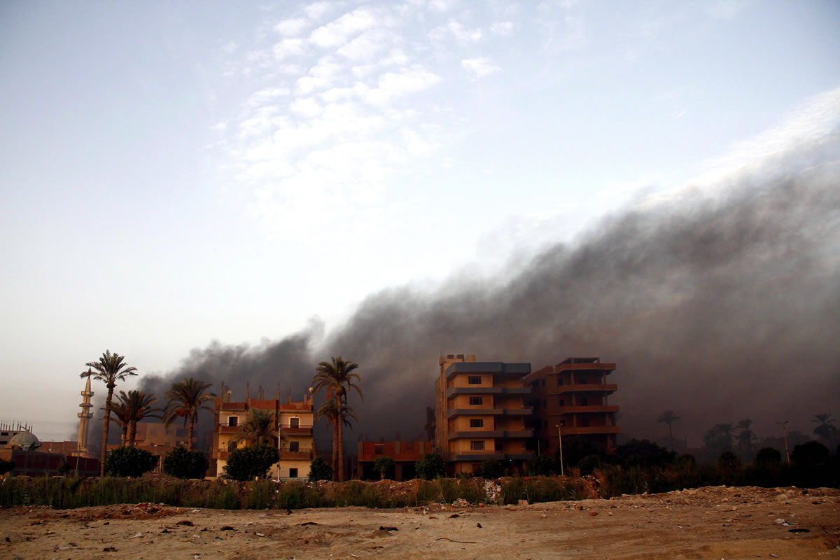 Smoke rises during clashes between Egyptian security forces and suspected militants in the town of Kerdasa, near Giza Pyramids, Egypt, on Thursday.