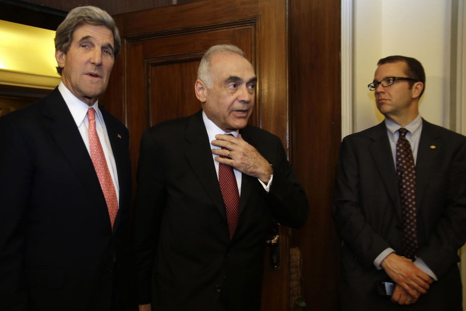 Egyptian Foreign Minister Mohammed Kamel Amr, center, enters a news conference with U.S. Secretary of State John Kerry to speak to the media Saturday at the Ministry of Foreign Affairs in Cairo, Egypt.