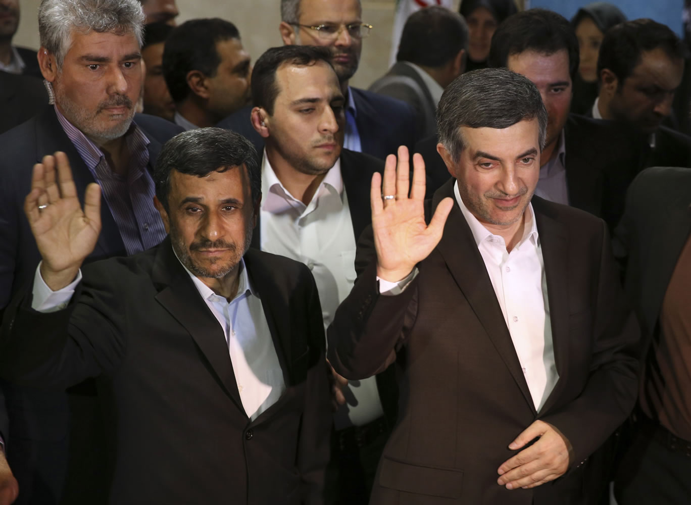 Iranian President Mahmoud Ahmadinejad, left, and his close ally Esfandiar Rahim Mashaei wave to journalists as they arrive at the election headquarters of the interior ministry for registering Masheaei's candidacy for the upcoming presidential election, in Tehran, Iran.