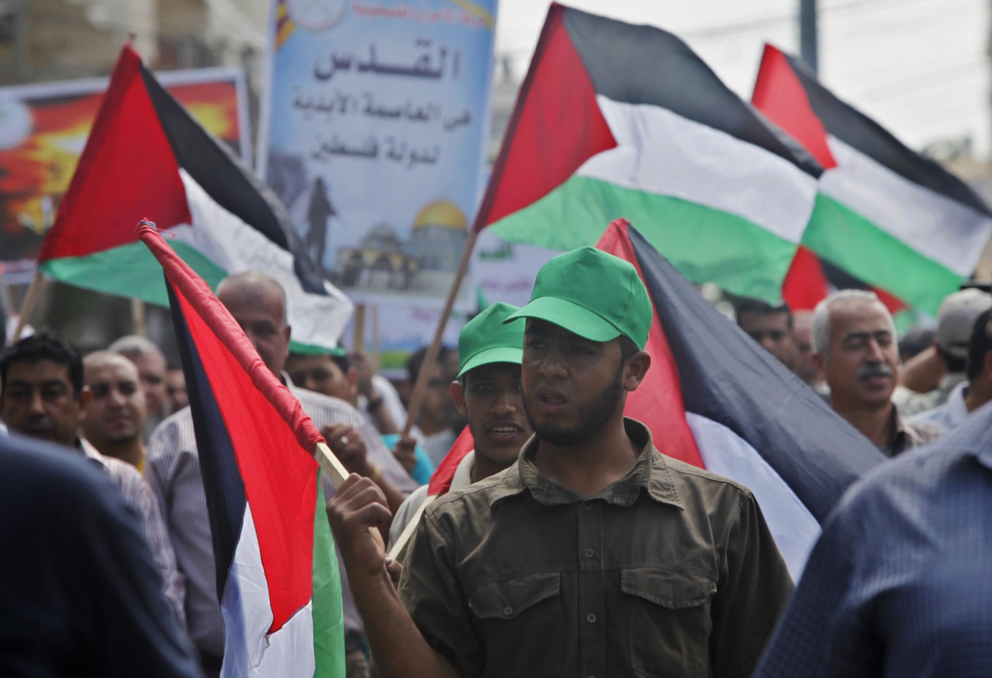 Palestinians wave their national flags during a protest to condemn what protesters claim was a desecration of Al-Aqsa Mosque in Jerusalem by Jewish extremists in Gaza City on Wednesday.