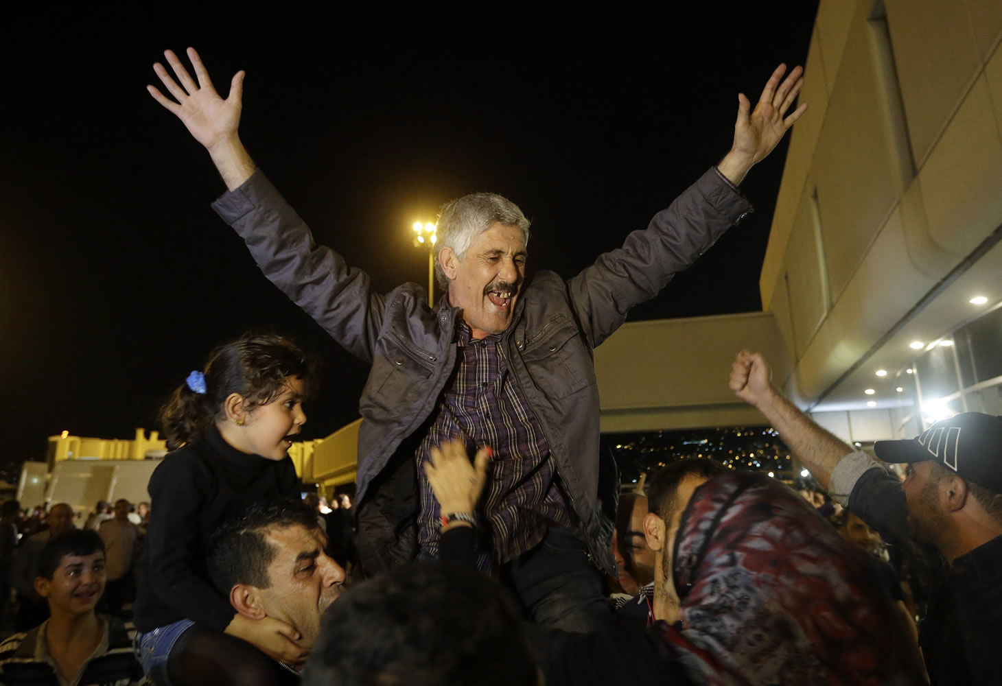 One of the nine released Lebanese pilgrims celebrates upon his arrival at the airport in Beirut on Saturday.