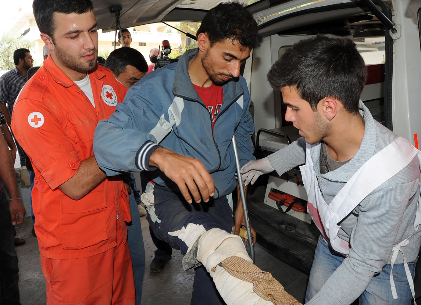Associated Press
Members of the Lebanese Red Cross at a hospital in the Bekaa Valley, east of Beirut, help a Syrian man Saturday who was wounded in Qusair, Syria, during battles between rebels and Syrian government forces. A Lebanese Red Cross official said they evacuated 28 people who were wounded in Qusair from the Syrian border.