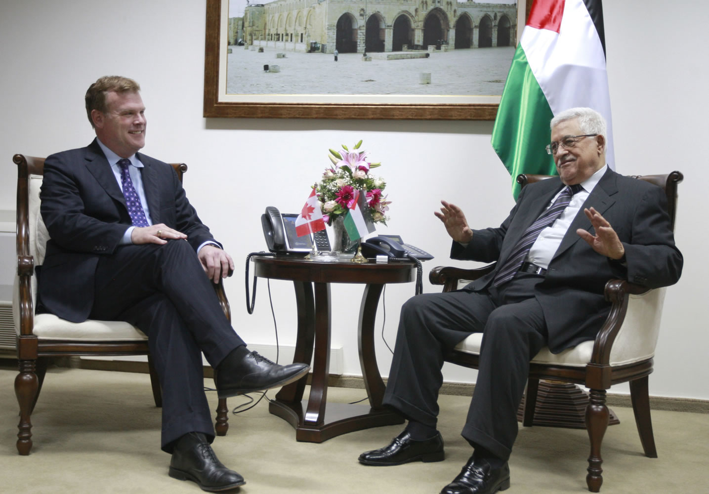 Palestinian President Mahmoud Abbas, right, speaks with Canada's foreign minister John Baird during their meeting in the West Bank city of Ramallah on Monday.