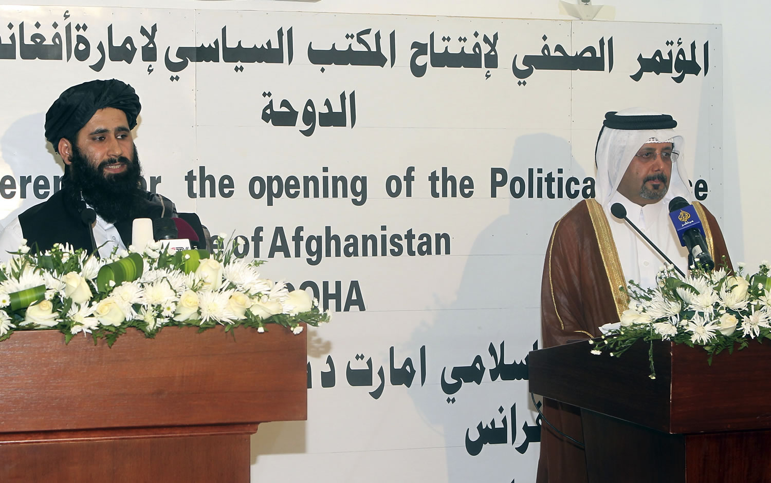Qatari Assistant Minister for Foreign Affairs Ali bin Fahd al-Hajri, right, and Muhammad Naeem a representative of the Taliban attend a press conference at the official opening of the Taliban office in Doha, Qatar, on Tuesday. In a major breakthrough, the Taliban and the U.S.