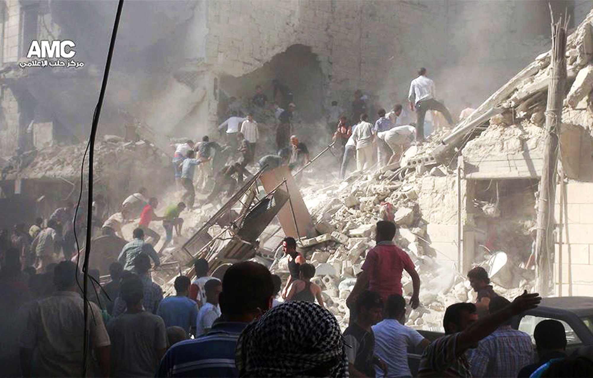 Syrians inspect the rubble of damaged buildings due to heavy shelling by Syrian government forces in Aleppo, Syria, on Monday.