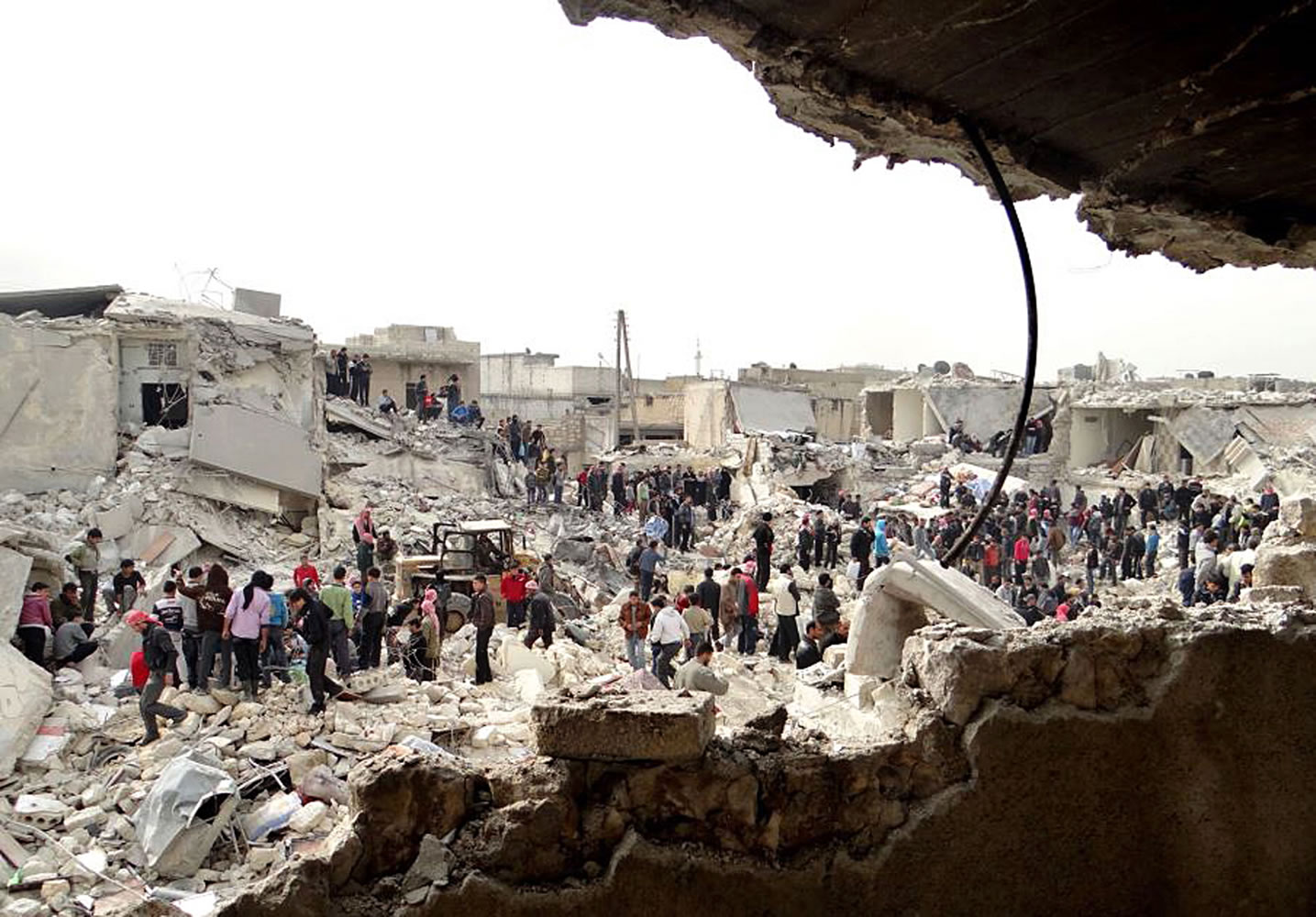 An provided by Aleppo Media Center AMC, which has been authenticated based on its contents and other AP reporting, shows people searching the rubble for bodies and injured victims at a site were houses were hit by a missile attack by Syrian government forces in the neighborhood of Ard Al-Hamra, Aleppo, Syria, on Tuesday.