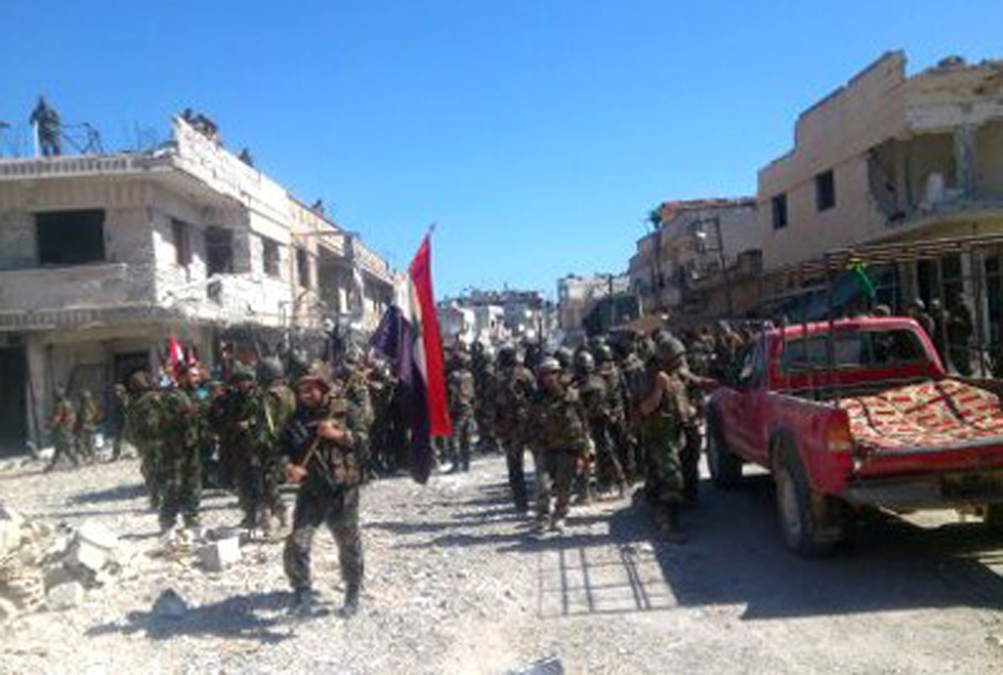 This photo released by the Syrian official news agency SANA shows Syrian army troops in the town of Qusair on Wednesday.