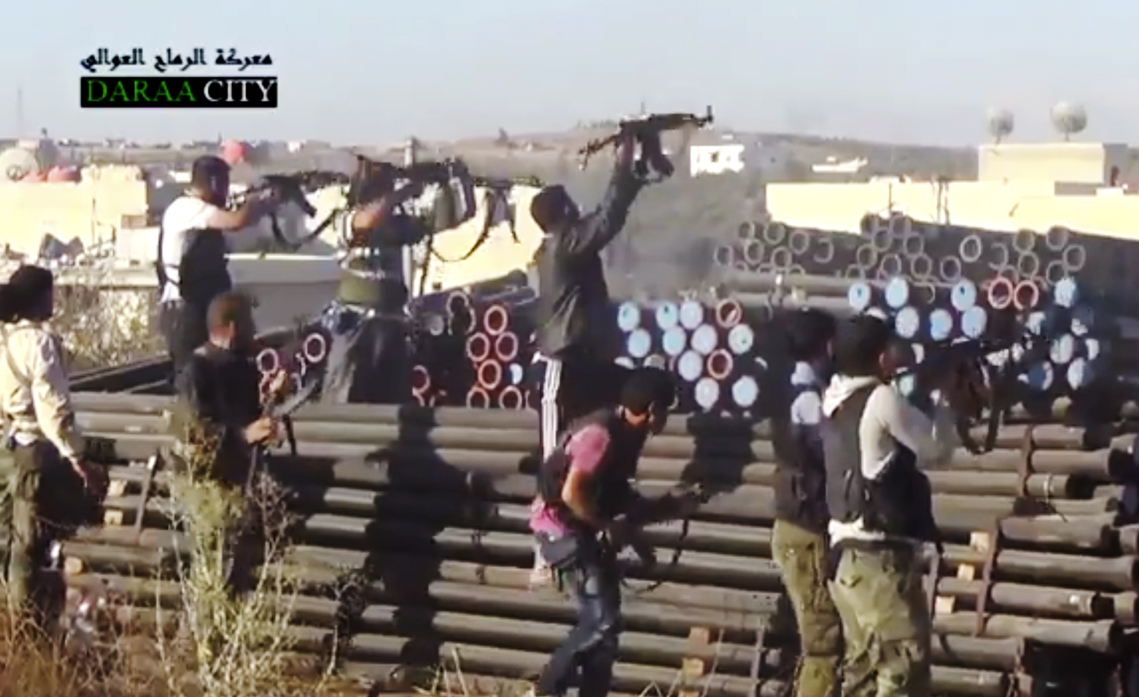 Syrian opposition fighters fire at government forces near Daraa customs in Daraa al-Balad, Syria.