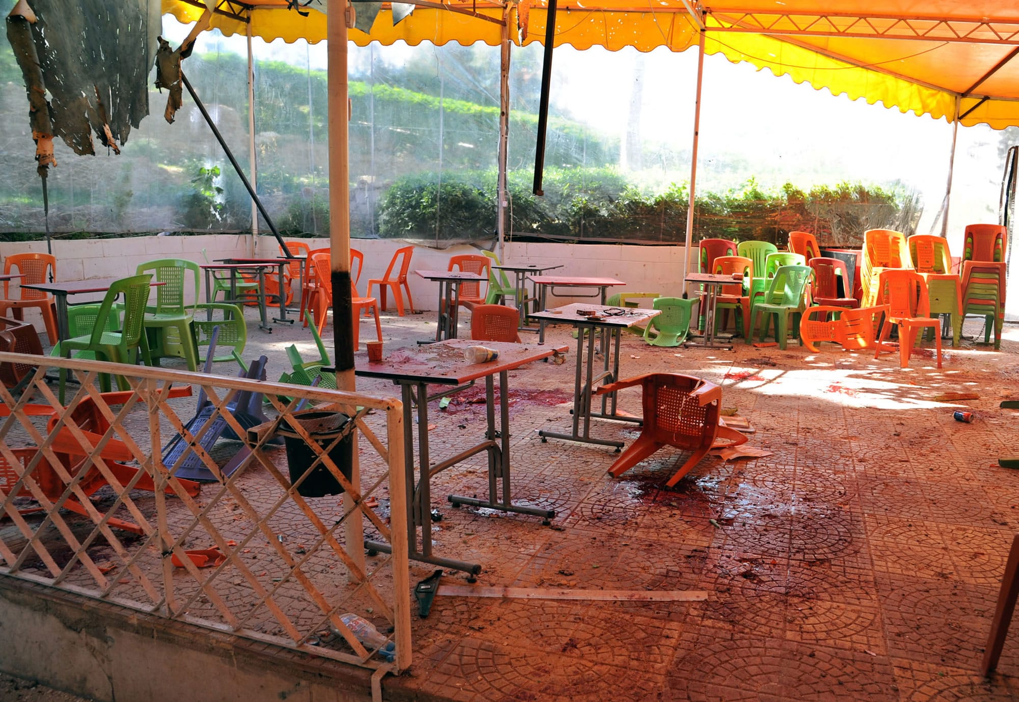 Plastic tables and chairs turned upside down are seen on the floor of the open-air cafeteria at Damascus University in the central Baramkeh district in Damascus, Syria, on Thursday.