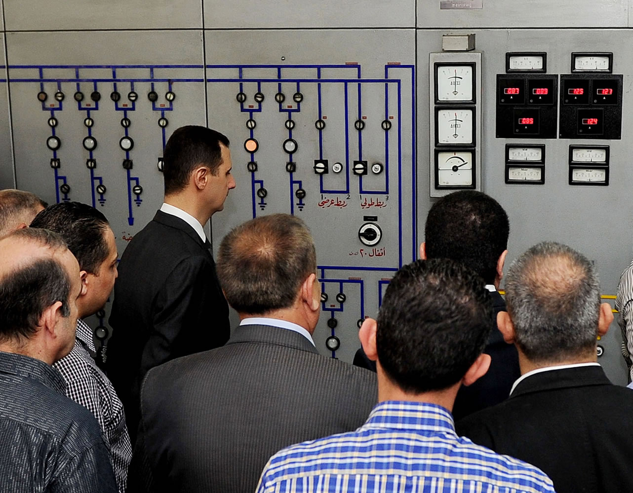 President Bashar Assad, left, visits the Umayyad Electrical Station on May Day, a day after a powerful bomb hit the capital in Damascus, Syria, on Wednesday.