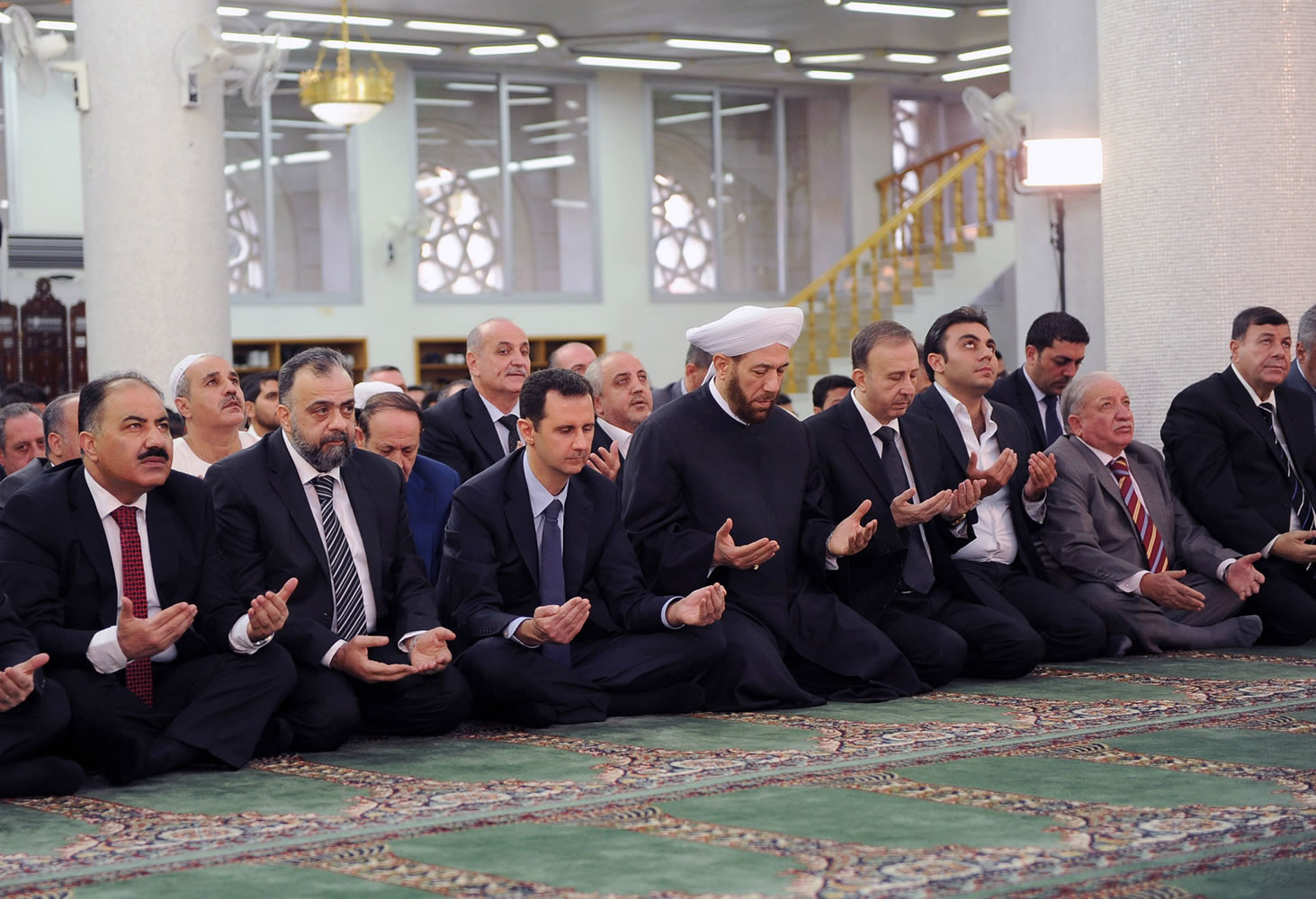 Syrian President Bashar Assad, third left, prays on the first day of Eid al-Adha at the Sayeda Hassiba mosque in Damascus, Syria, on Tuesday.