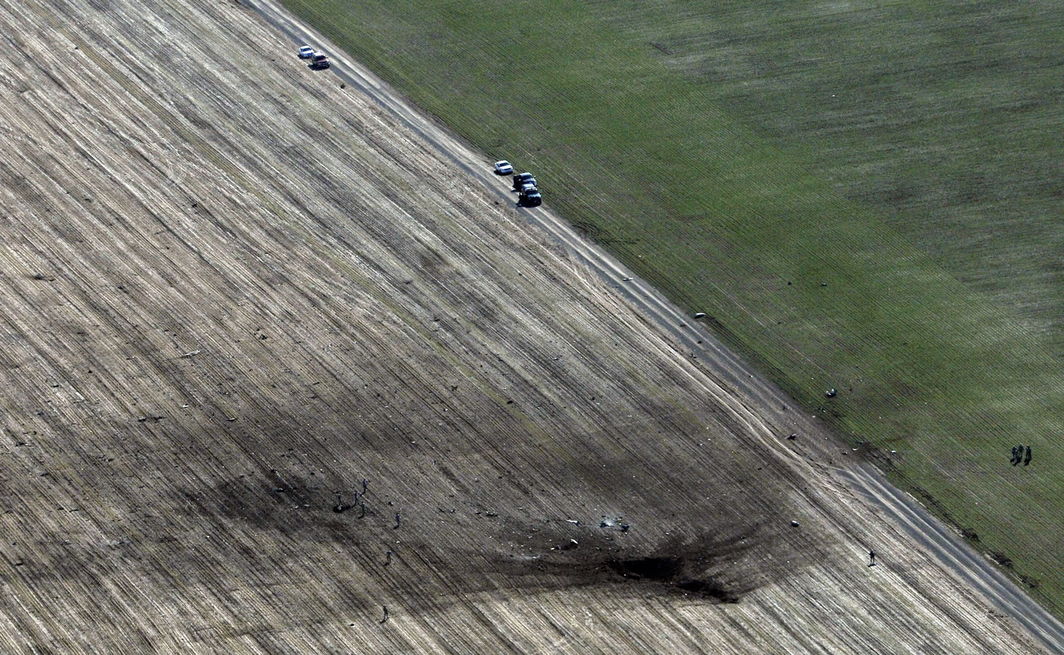A dark scar marks a farm field at the site of a crash of a Navy aircraft Monday near Harrington, in Eastern Washington. A U.S.