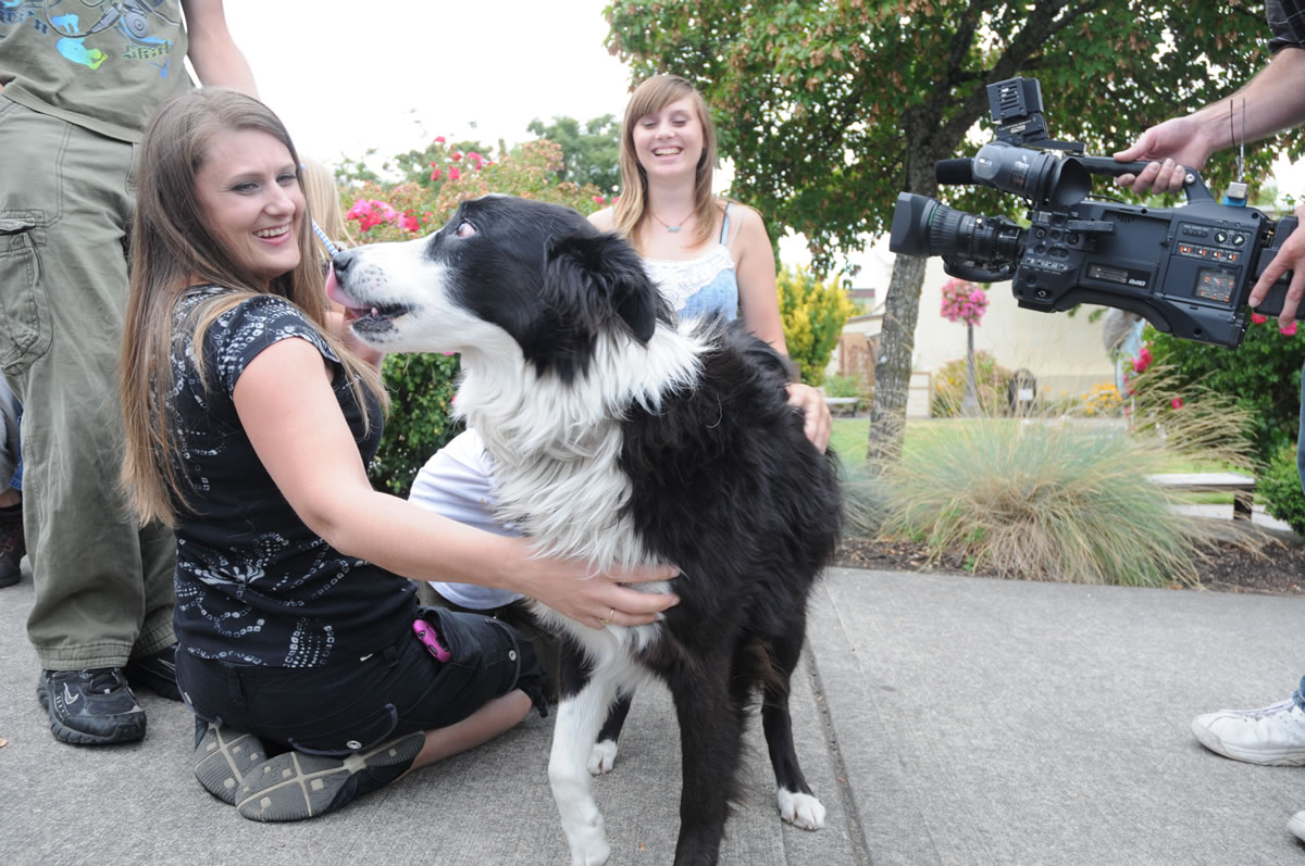 Kristin Riccitti of Aumsville, Ore. welcomes  her dog, Sara home Sunday, Aug. 26 during a reunion at a park in Troutdale, Ore. The dog has been missing for nearly three years and recently was discovered roaming in a canyon in Utah.