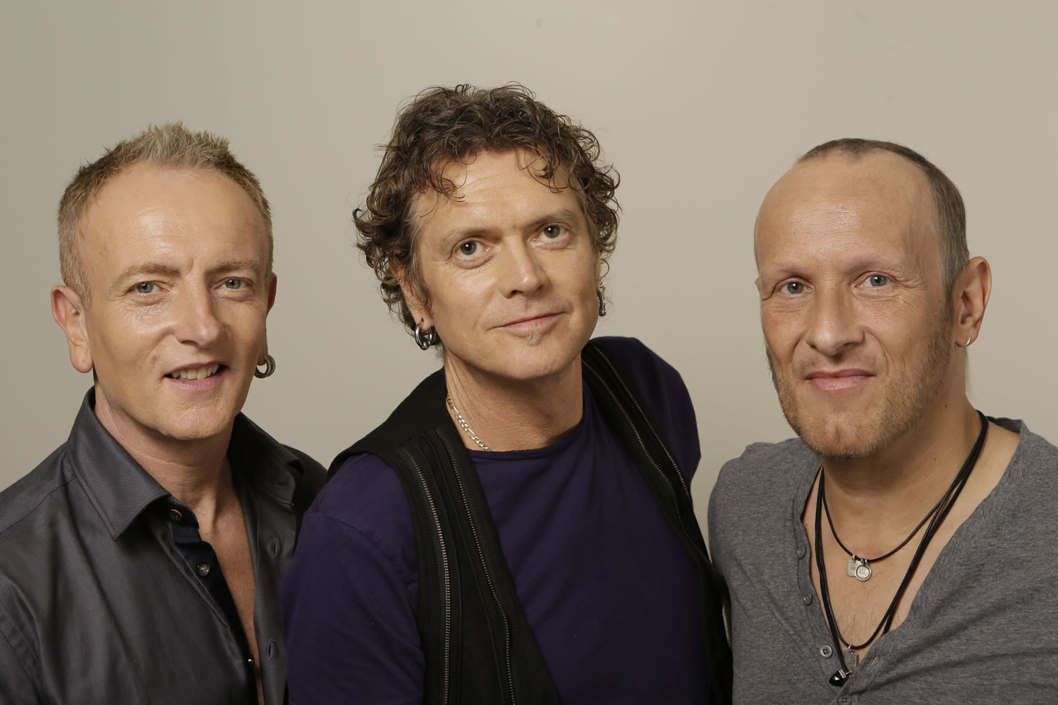 In this photo taken Wednesday, Sept. 25, 2013, British rock group, Def Leppard, from left, Phil Collen, Rick Allen and Vivian Campbell pose for a photo in Los Angeles. First up, in a year of firsts for the band, is the special-event screening Wednesday, Oct. 1, 2013, (and again on Oct. 8) of their live concert film at theaters nationwide iDef Leppard Viva!
