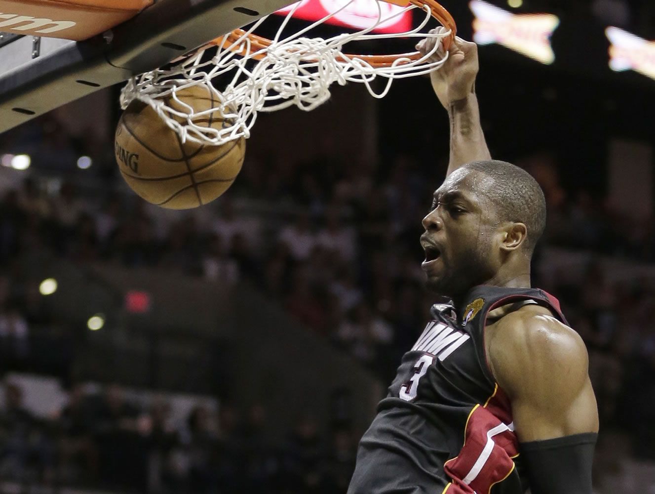 Miami Heat's Dwyane Wade (3) dunks against the San Antonio Spurs during the second half at Game 4 of the NBA Finals basketball series, Thursday, June 13, 2013, in San Antonio.