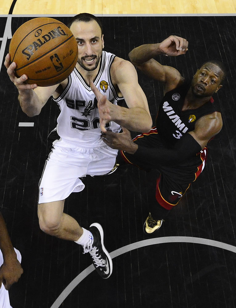 San Antonio's Manu Ginobili (20) drives to the basket past Miami's Dwyane Wade during the second half of Game 5 of the NBA Finals.