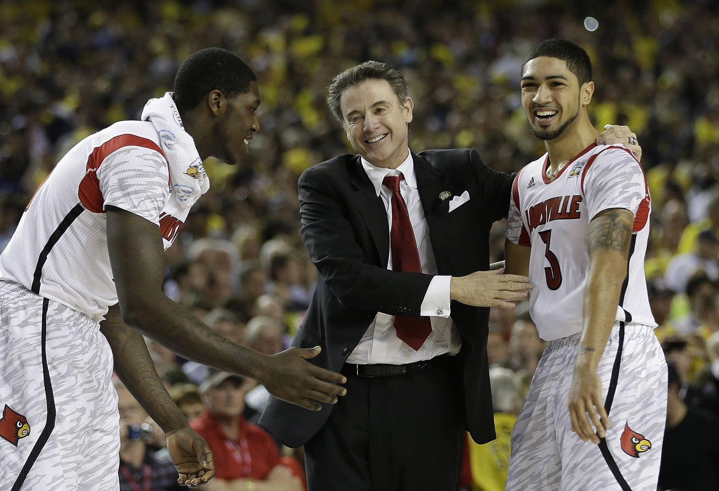 Louisville head coach Rick Pitino celebrates with Louisville guard Peyton Siva (3) defeating Michigan 82-76 for the national championship.