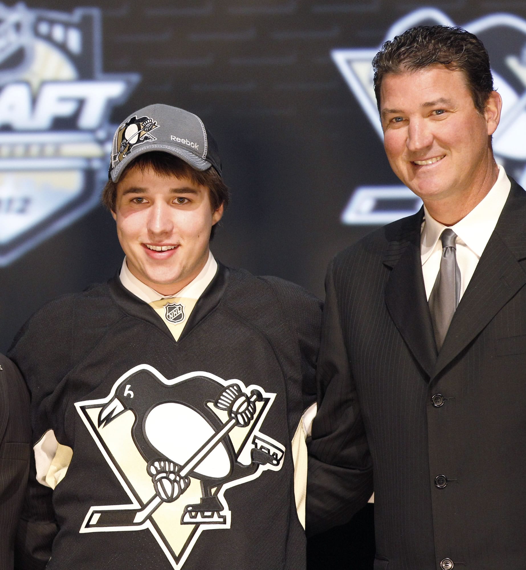 Portland Winterhawks' Derrick Pouliot stands alongside Mario Lemieux after being drafted No.