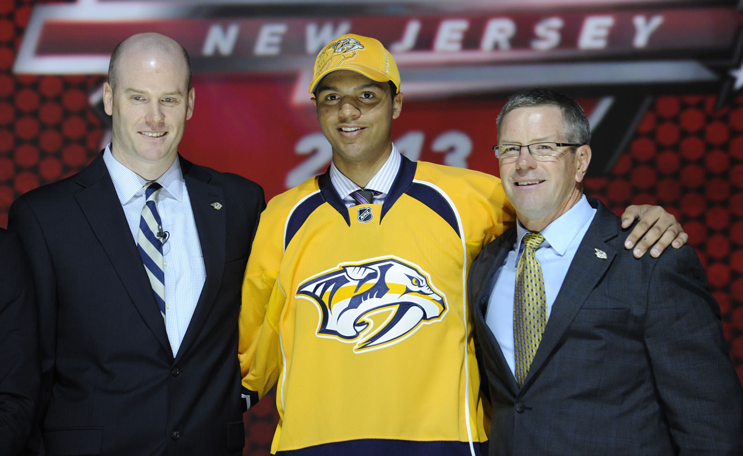 Portland Winterhawks Seth Jones stands with officials from the Nashville Predators after being chosen 4th overall in the first round of the NHL hockey draft on Sunday.