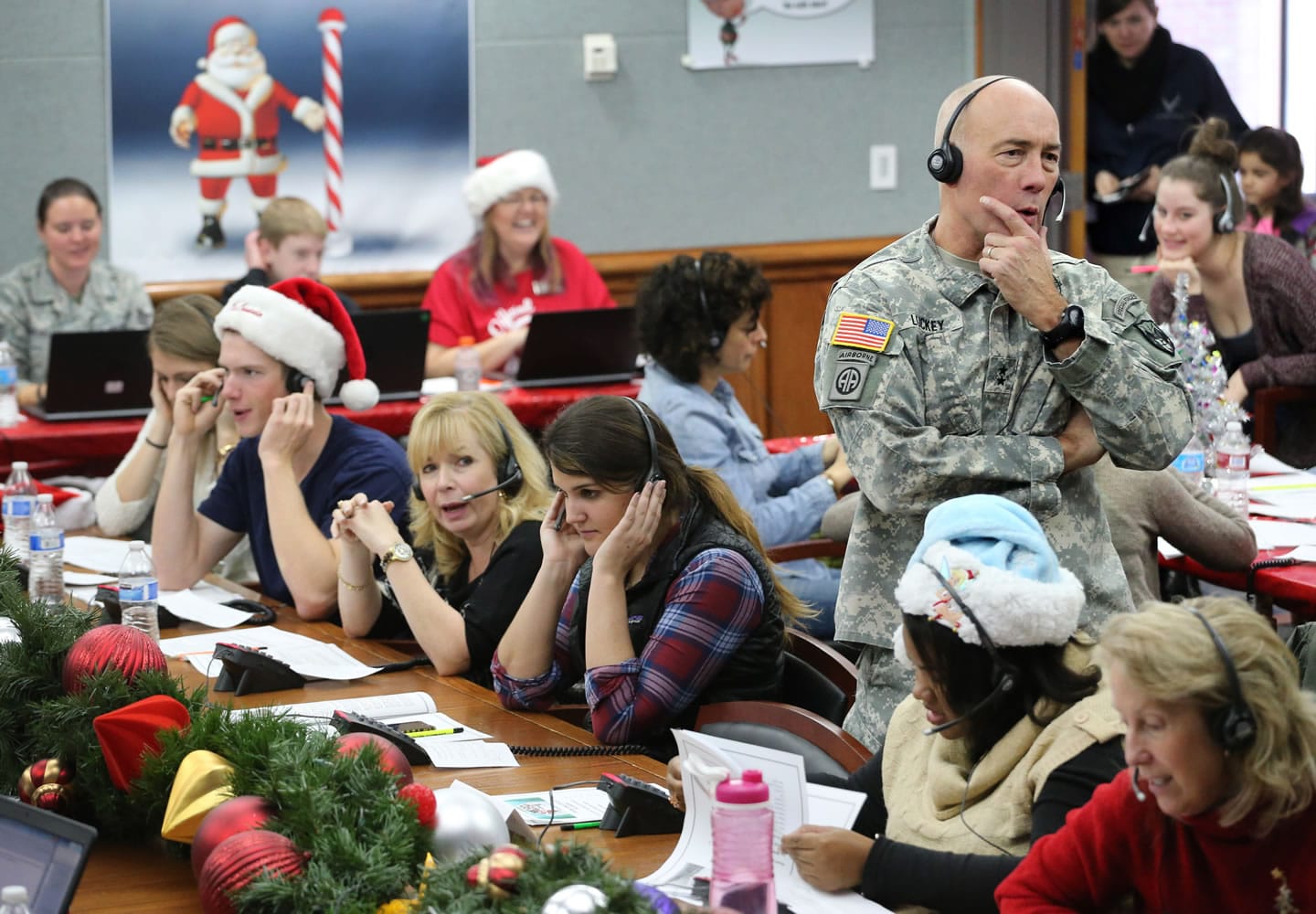 NORAD and U.S. Northern Command (USNORTHCOM) Chief of Staff Maj. Gen. Charles D. Luckey joins other volunteers taking phone calls from children around the world asking where Santa is and when he will deliver presents to their homes, inside a phone-in center during the annual NORAD Tracks Santa Operation, at the North American Aerospace Defense Command, at Peterson Air Force Base, Colo. , in 2014. Hundreds of military and civilian volunteers at NORAD are estimated to field more than 100,000 calls this year through Christmas Eve, from children from all over the world eager to hear about Santa's progress.