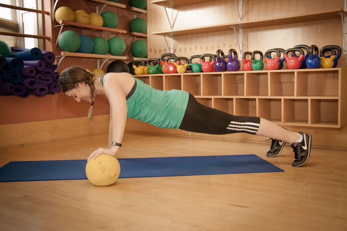 Beth Goldstein performs a medicine ball pushup.