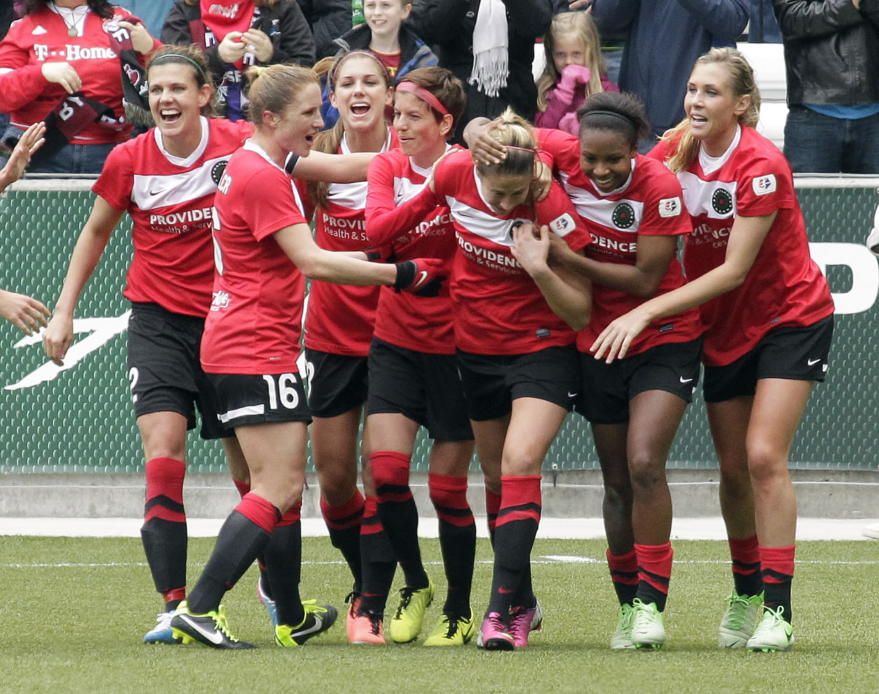 The Portland Thorns celebrate after Marian Dougherty, third from right, scored the team's first goal on Sunday.
