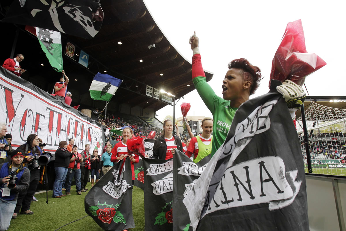 Portland Thorns goalie Karina LeBlanc, right, celebrates with teammates and fans after their National Women's Soccer League 2-1 victory over the Seattle Reign on Sunday.