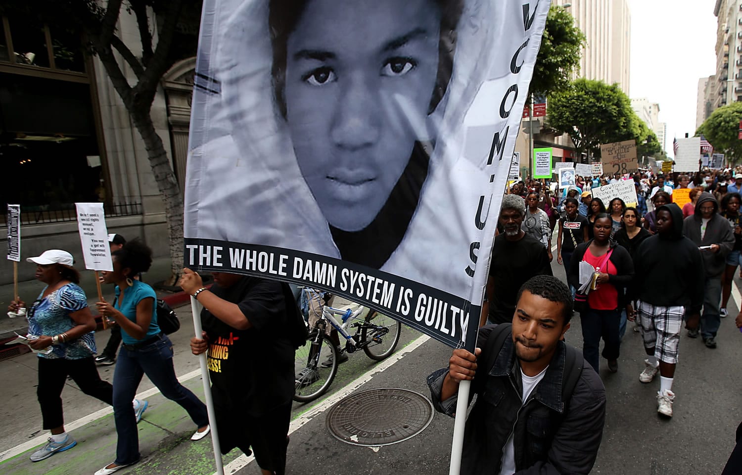 People participate during a rally and march in downtown Los Angeles on Saturday. The Rev.