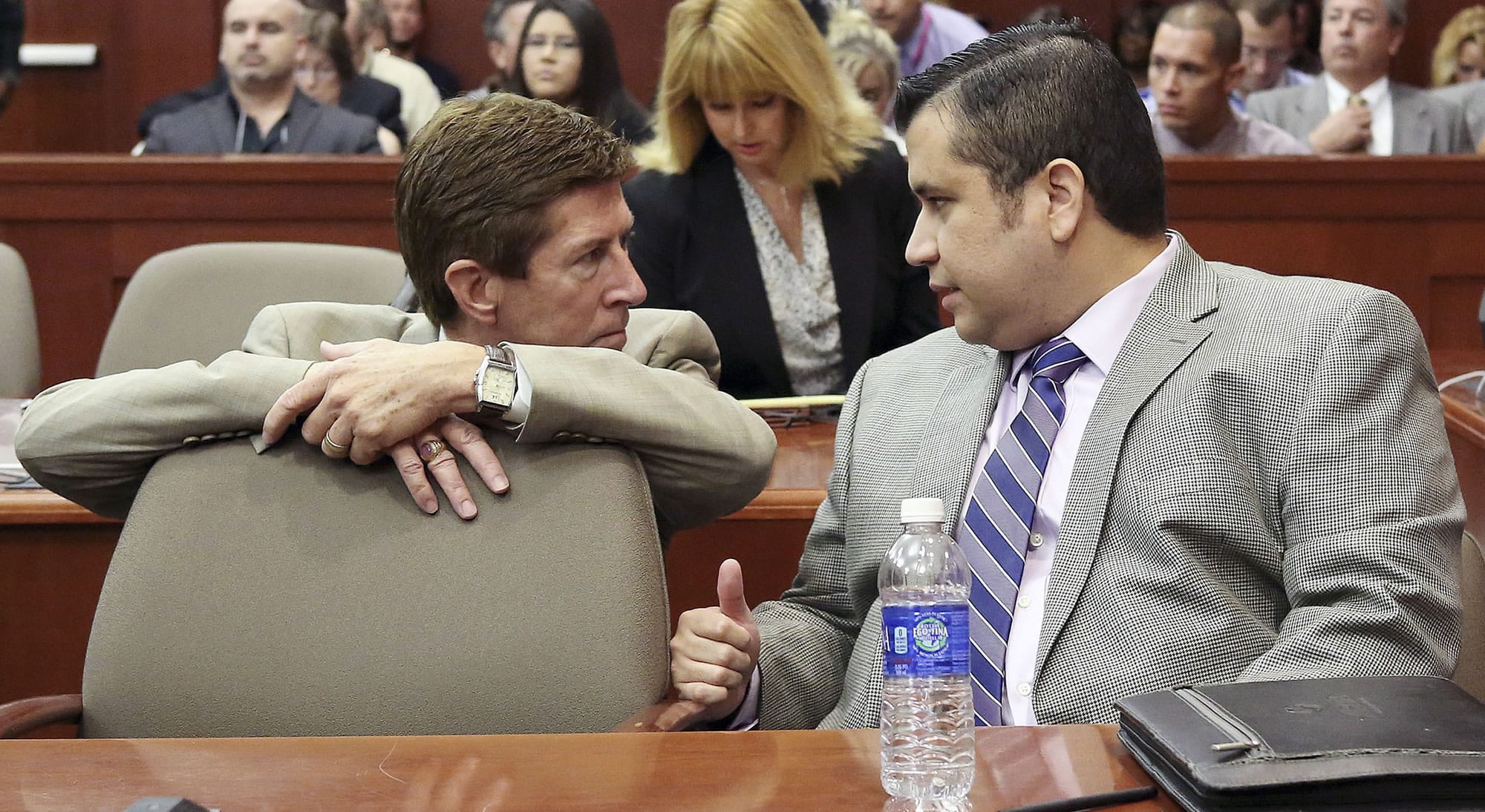 George Zimmerman, right, speaks with defense attorney Mark O'Mara during his trial in Seminole circuit court in Sanford, Fla., on Thursday.