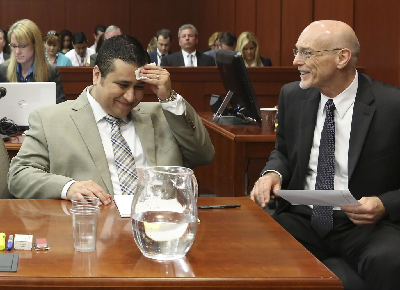 George Zimmerman, left, laughs with his attorney Don West during his trial in Seminole County circuit court in Sanford, Fla., on Tuesday.