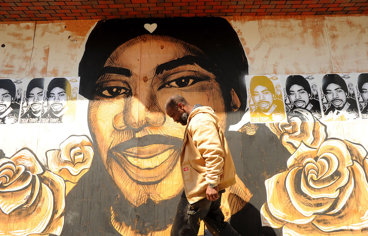A pedestrian passes a mural of Oscar Grant in Oakland, Calif., shortly before a jury delivered an involuntary manslaughter verdict in the trial of a former transit police officer, Johannes Mehserle, who shot and killed subway passenger Grant as he lay unarmed and face down on a station platform on New Year's Day 2009. Outrage over the incident led to riots in Oakland. The Justice Department investigated the case under great public pressure, but hasn't prosecuted. Prosecutors may not believe there is enough evidence that an attack was motivated by bias or that police officers willfully violated someone's civil rights.