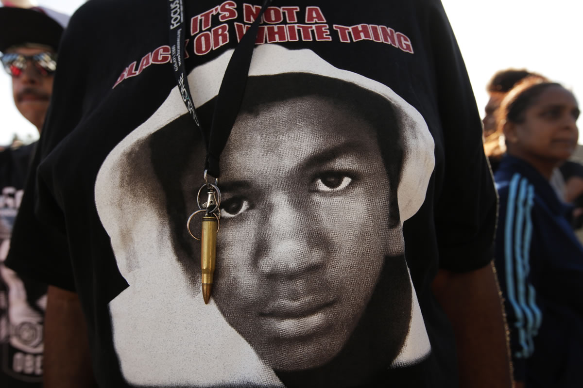An image of Trayvon Martin and a bullet shell keychain hanging from a protester's lanyard are seen during a demonstration in reaction to the acquittal of neighborhood watch volunteer George Zimmerman on Monday in Los Angeles.